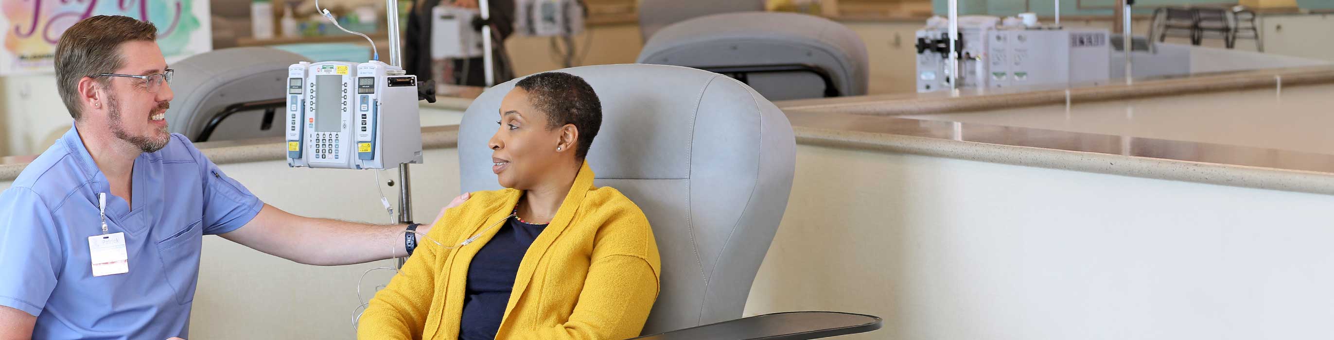 Registered nurse smiling with a patient.