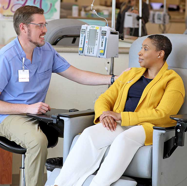 Registered nurse smiling with a patient.