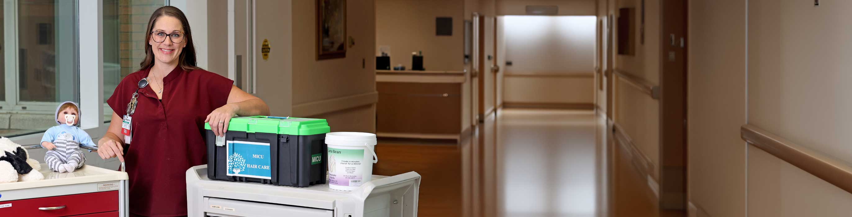 A smiling nurse with hospital supplies.