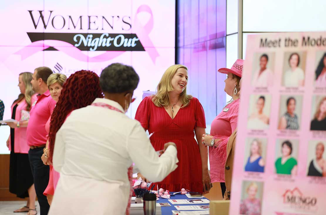 Women smiling and chatting at the Women's Night Out event.